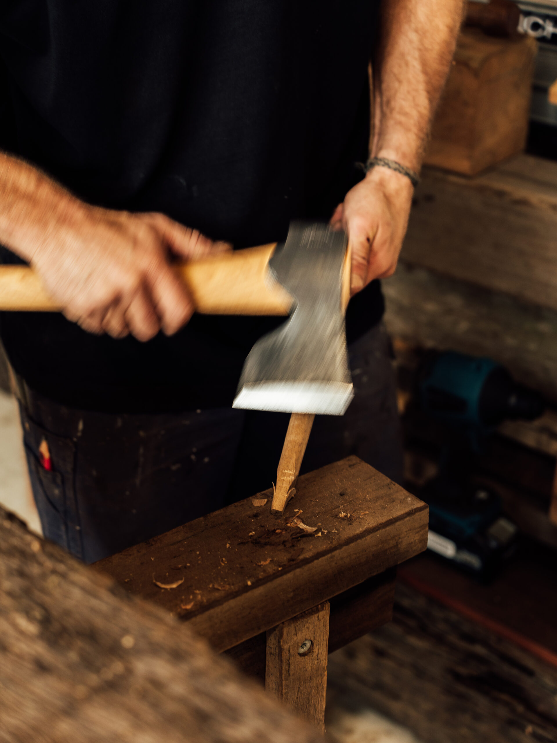 Swinging a hand axe at a timber post