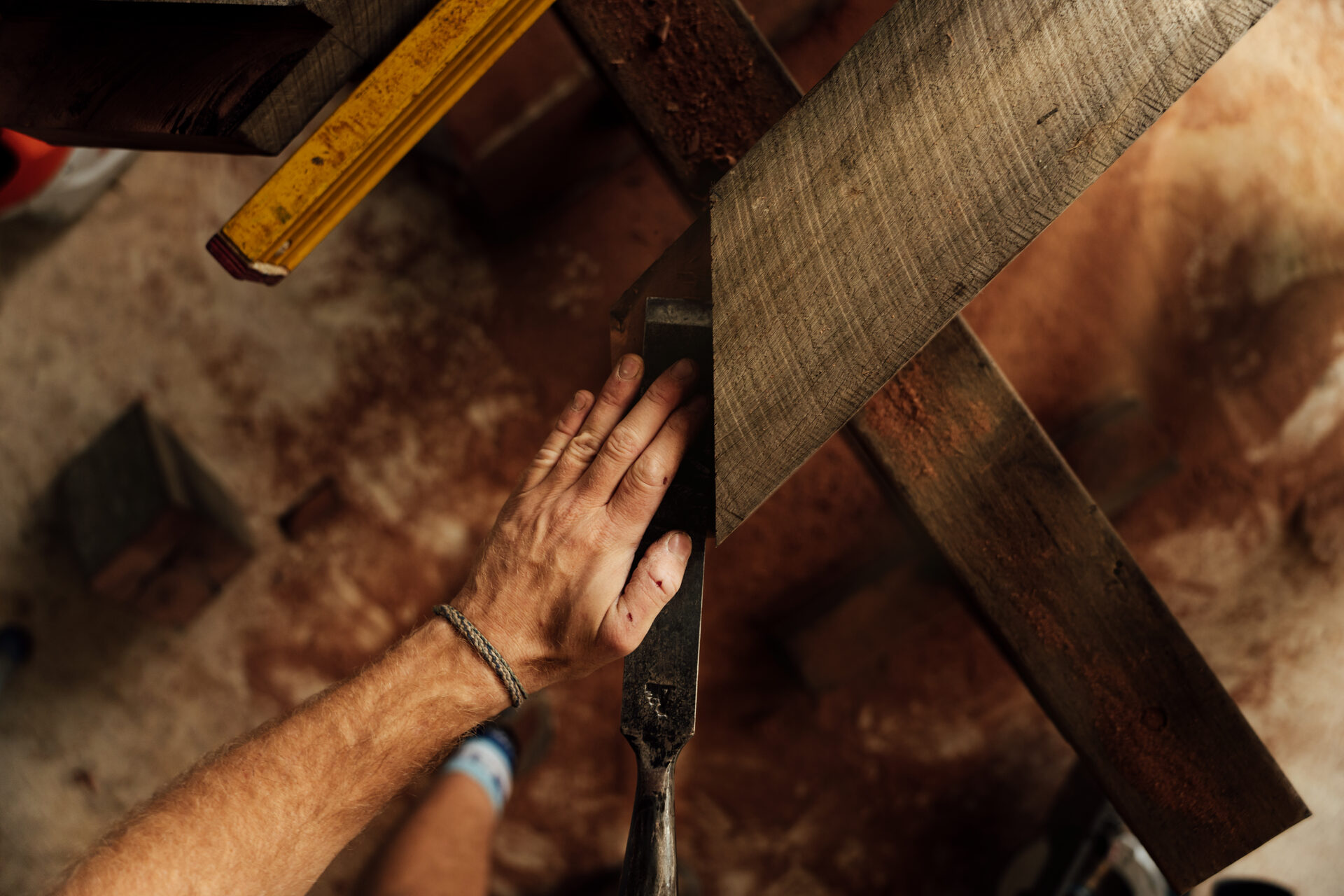 Hands positioning a diagonal corner joint, seen from above